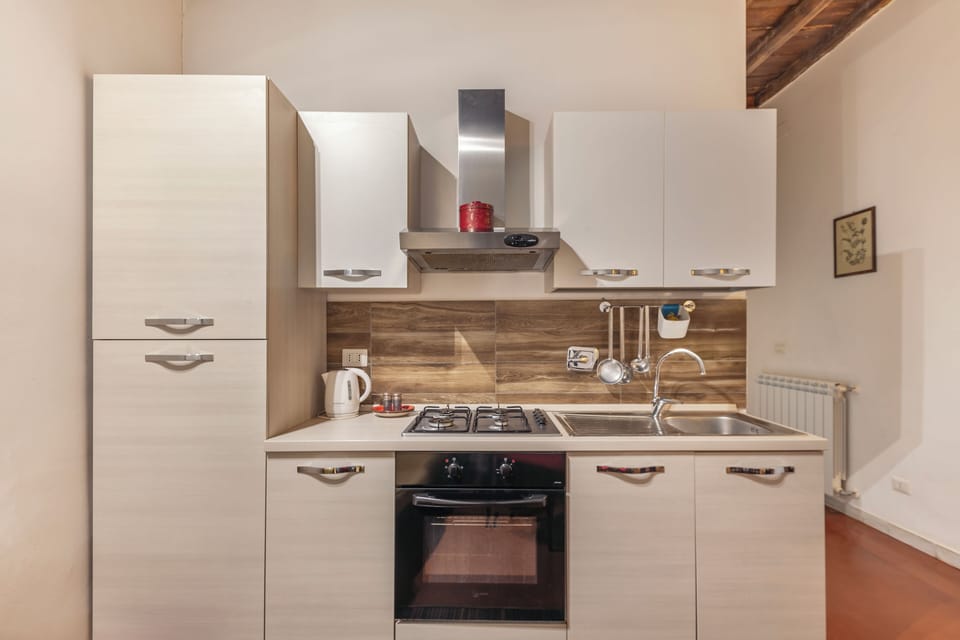 Fully equipped kitchen and living–dining area.