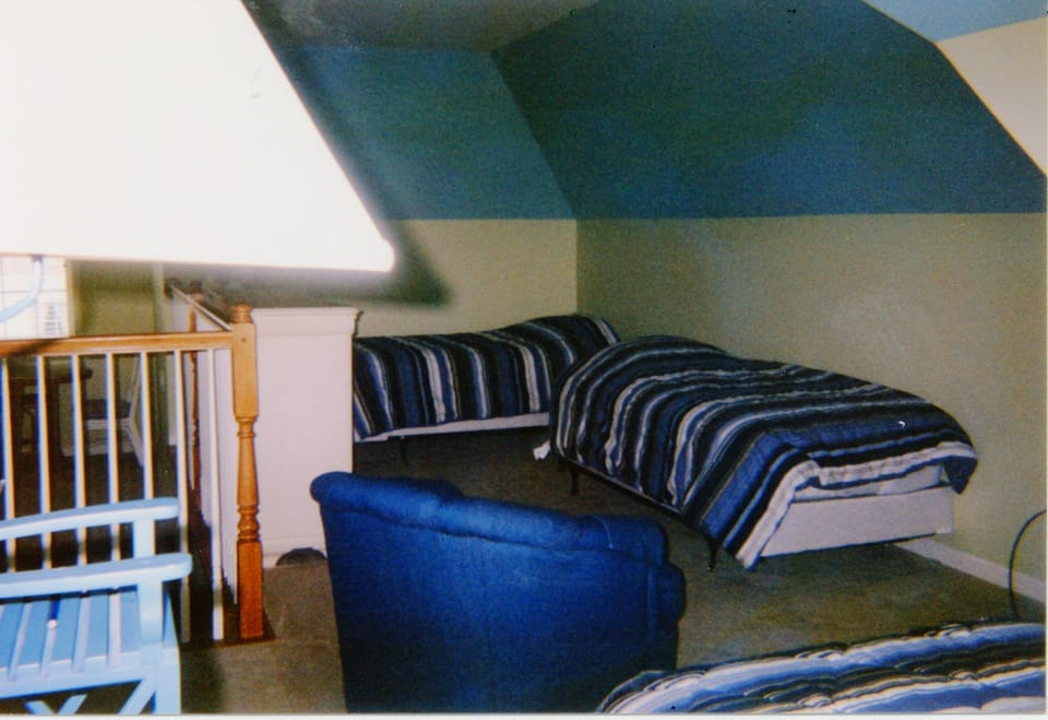 semiprivate Loft with 3 twin beds, chairs, and TV