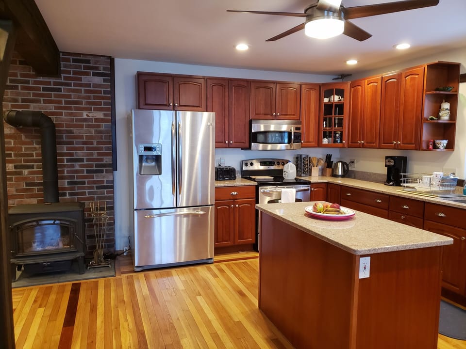 Newly renovated kitchen with stainless steel appliances and granite countertops.