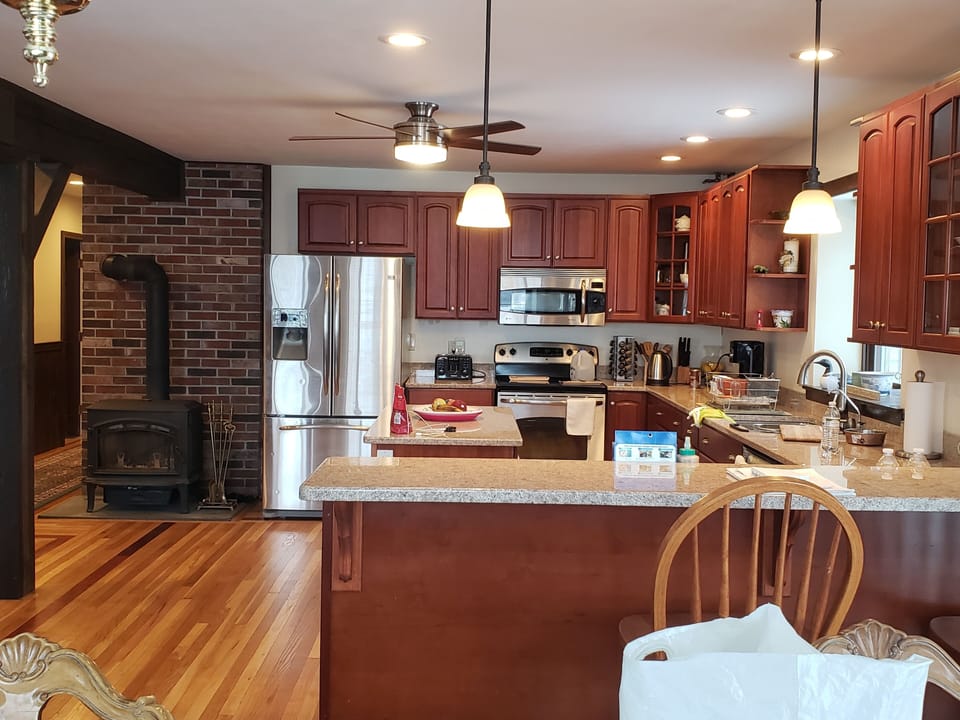 Newly renovated kitchen with stainless steel appliances and granite countertops.