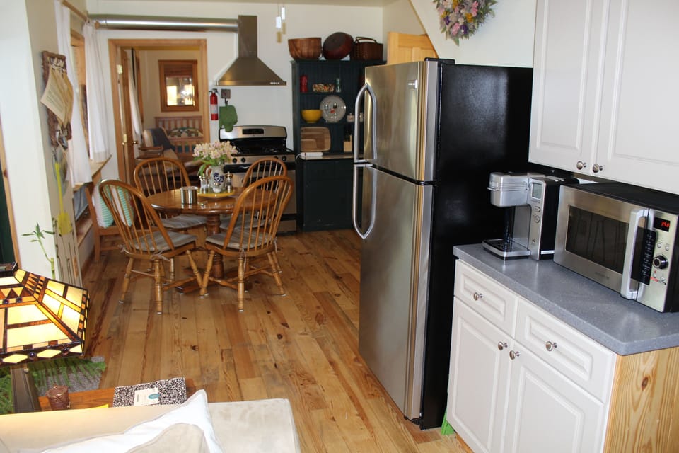 View of kitchen looking toward yellow bedroom K-coffee maker & microwave, right