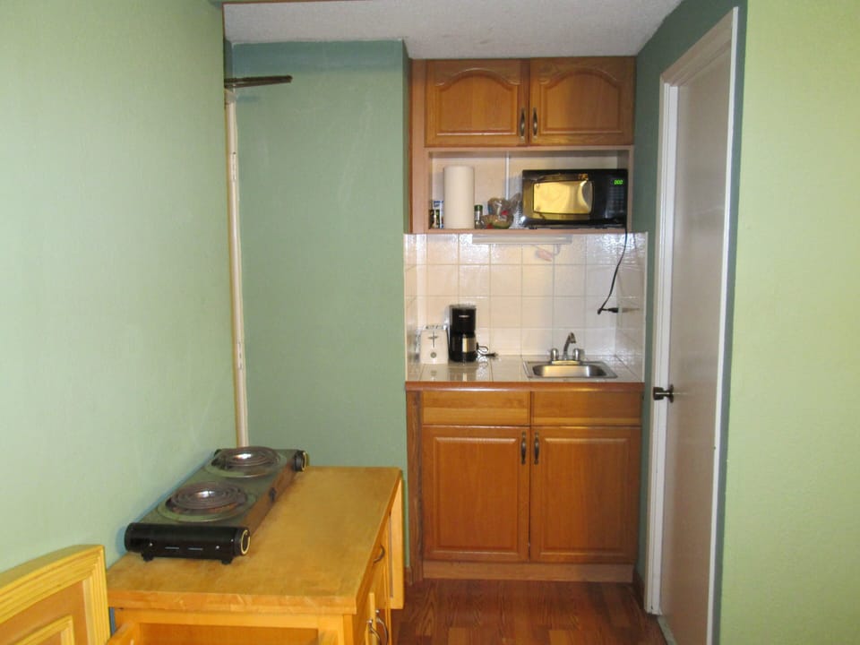 The full kitchenette includes a microwave, a refrigerator, coffee maker, hot double plate, rice maker, toaster and all utensils. There is also an iron and ironing board in the closet
