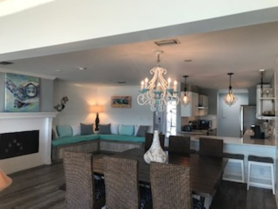 View into the living area - dining, sitting sleeping cove, kitchen with island. 
