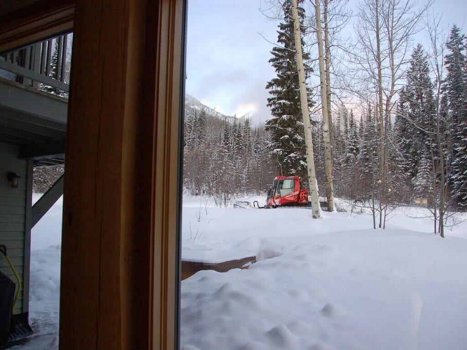 Snow cat grooming Hot tub out back door with snow cat grooming Ski trail to home