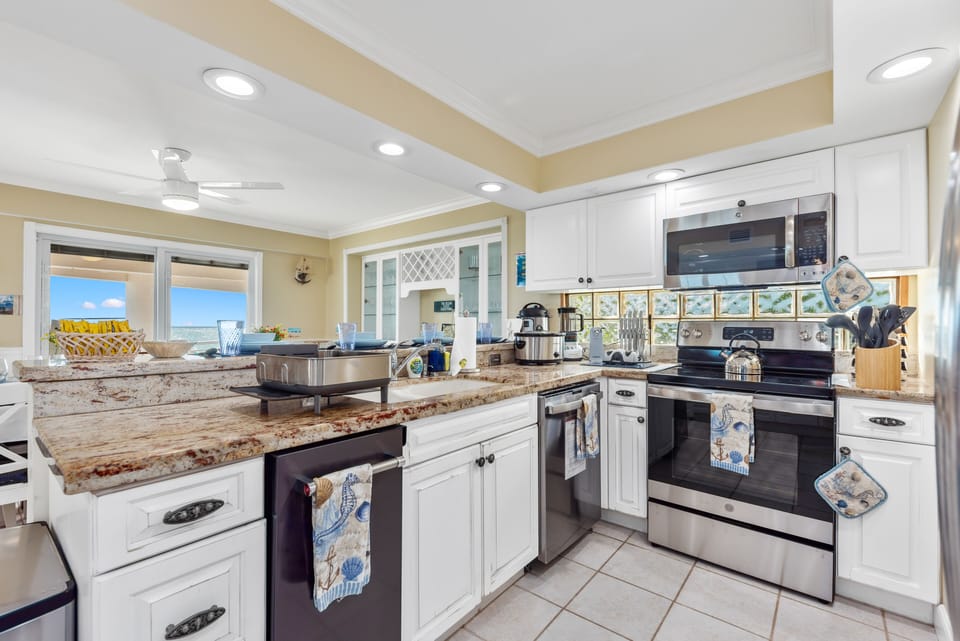 Open floor-plan kitchen with stainless steel GE appliances