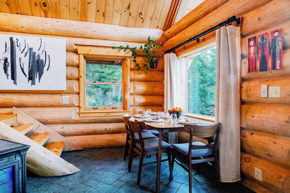 Dining area with table, four chairs, and tree views