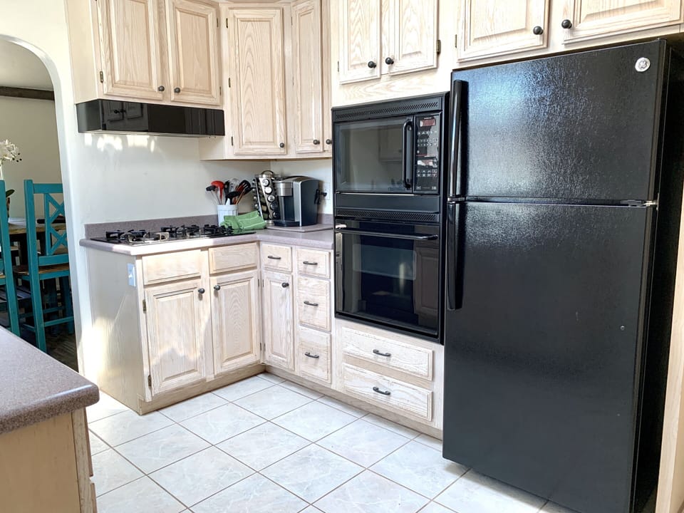 Fully stocked kitchen with gas range, microwave, and ice maker