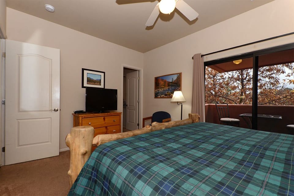 Back Bedroom with King Bed, Dresser, HDTV, Walk in Closet and Balcony