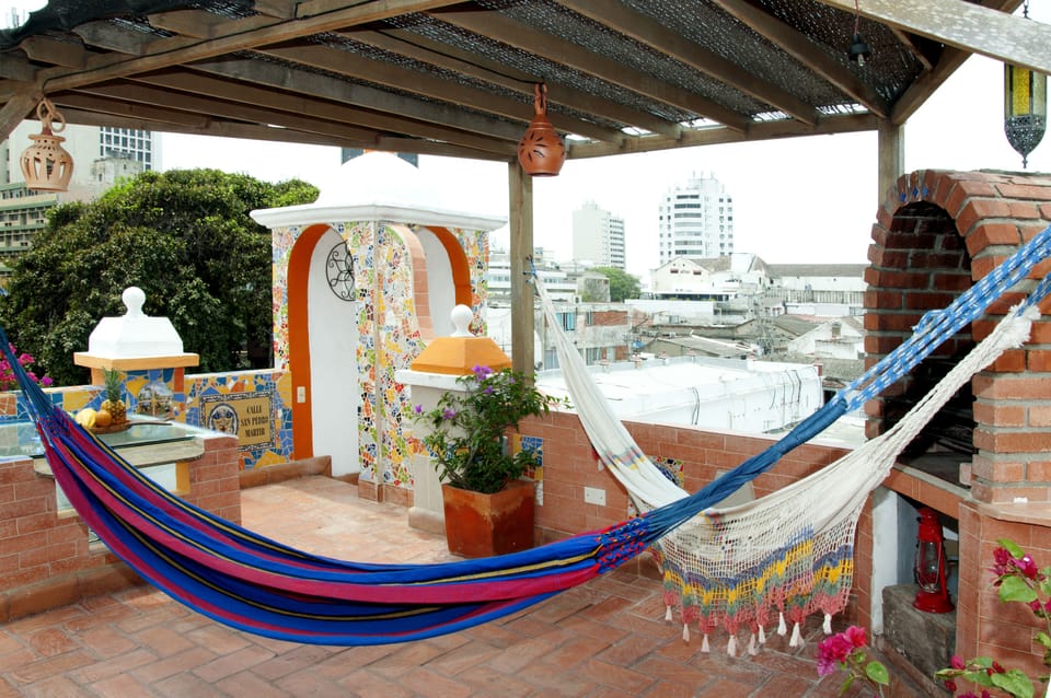 Rooftop retreat with handcrafted tile art and relaxing hammocks 
A serene space.