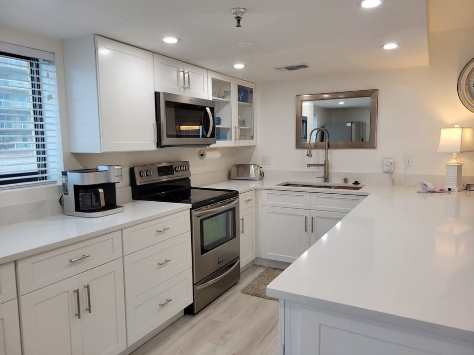 Kitchen with many cooking essentials.