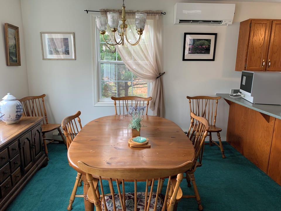 Dining table to left of entry. W/ extra leaf, can seat 6. Set up shown is for 4.