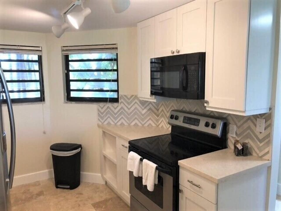 Top of the line stainless appliances, including a double oven, in the gourmet kitchen setup.