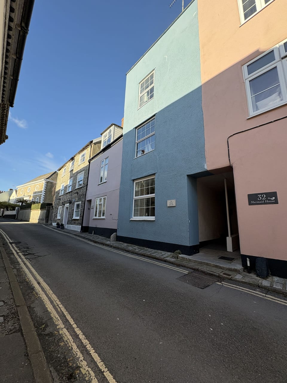 Teal House is the blue house.