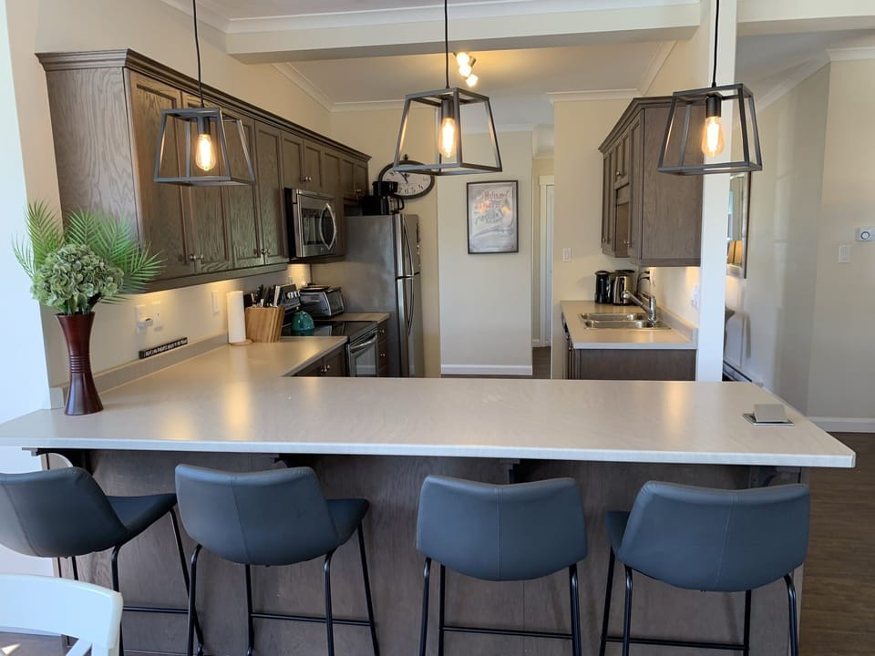 Bar seating overlooking kitchen. Kitchen fully kitted out for entertaining