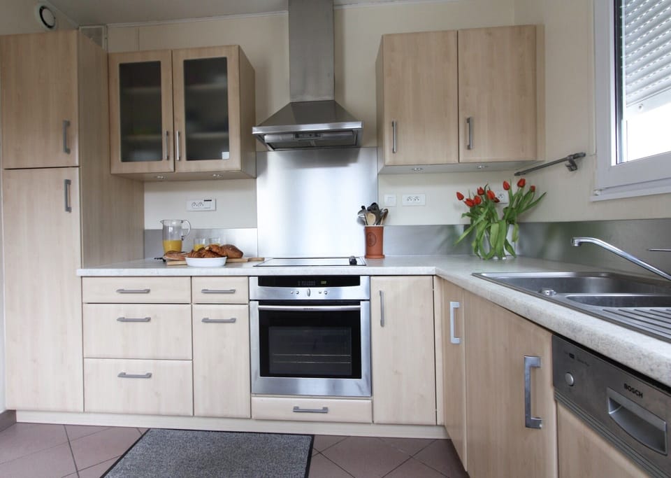 Fully equipped kitchen with access to courtyard.