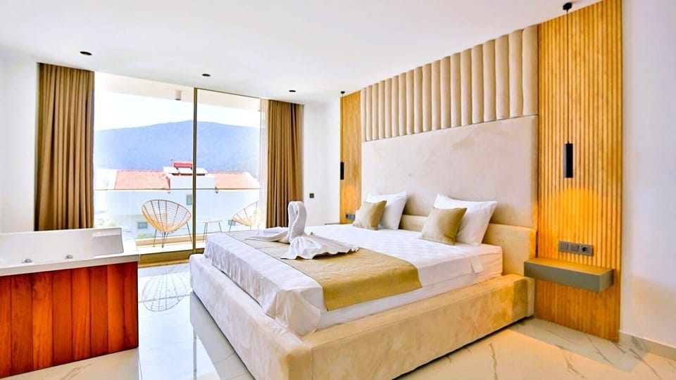 King-size bed with private sea-facing balcony. Private in-room jacuzzi. 