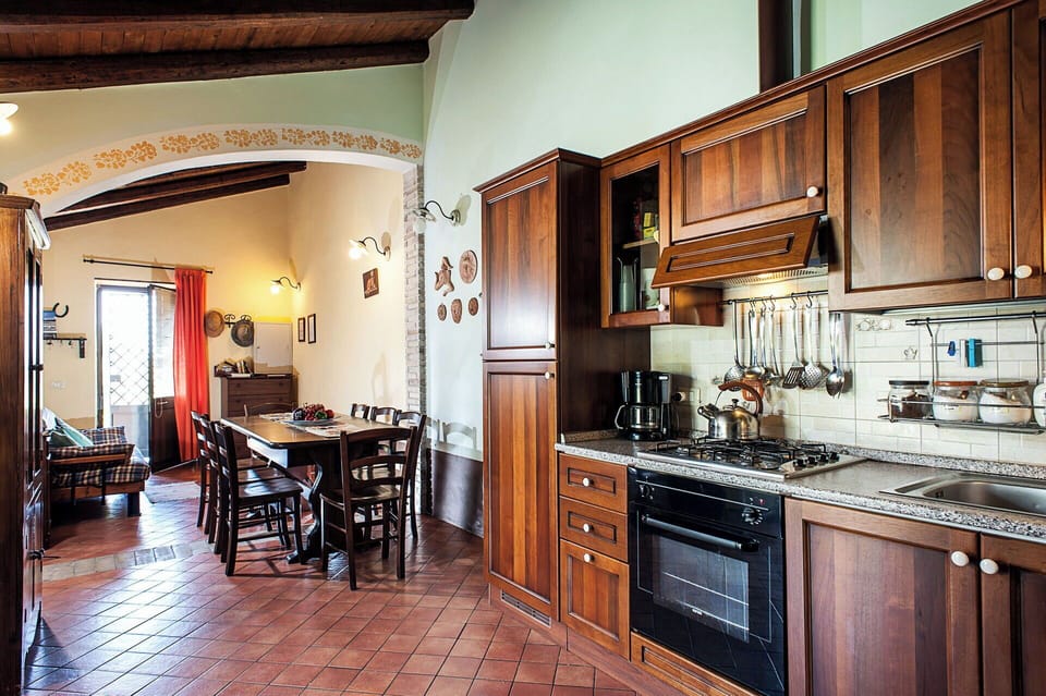 The kitchen opens onto the covered terrace, perfect for al fresco dining.