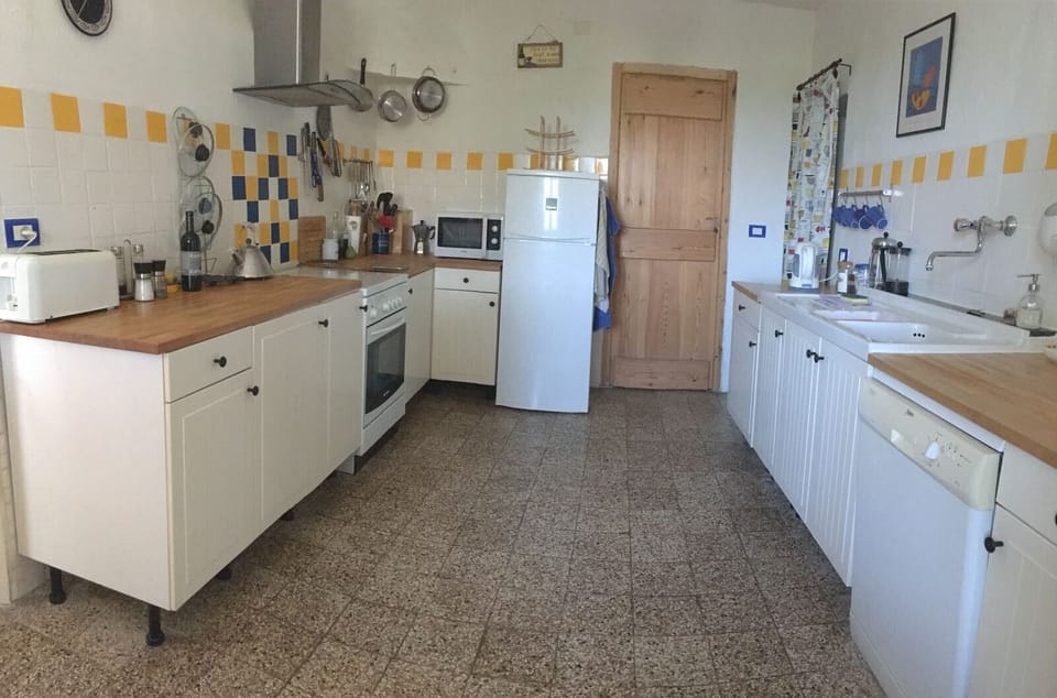 Kitchen, with under stair pantry and door to the cantina.