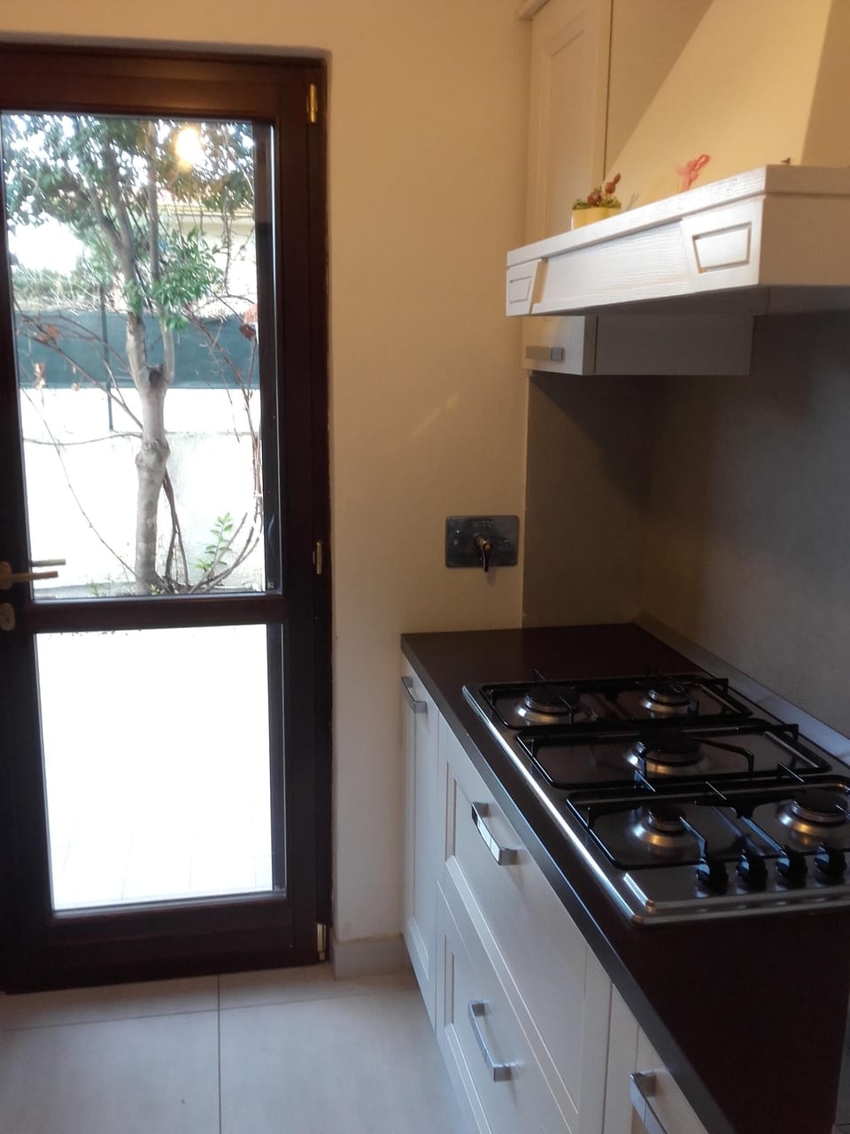 fully furnished kitchen with access to the patio