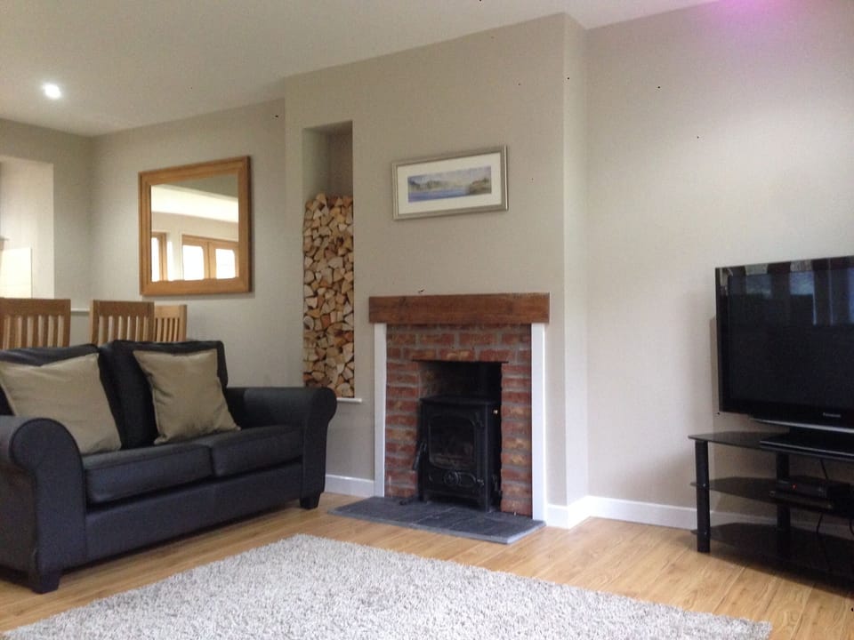 Spacious open plan living area with log burning stove