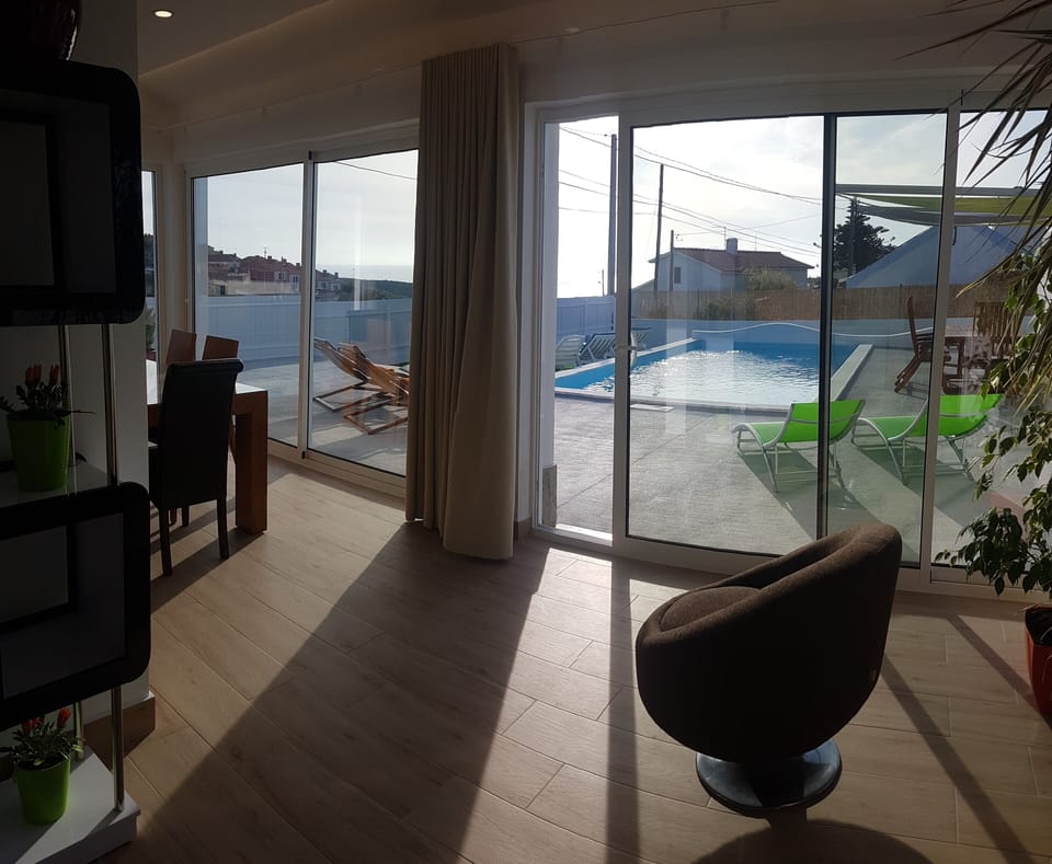 Indoor dining/kitchen area with pool and sea views