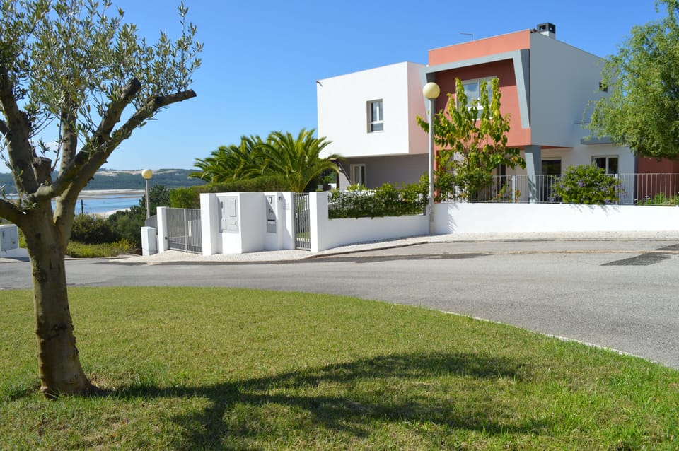 View of Casa Elena from the cul-de-sac with lagoon at the bottom of the hill.