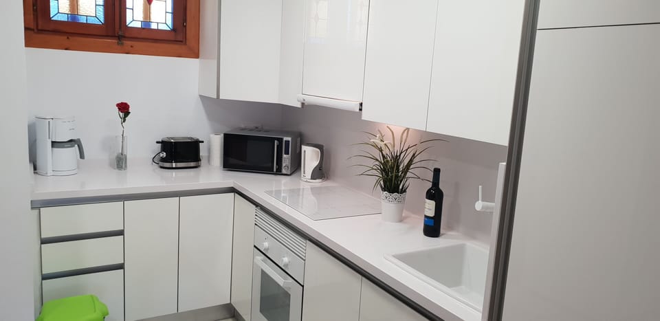 kitchen with oven, induction stove, microwave, coffee machine, toaster