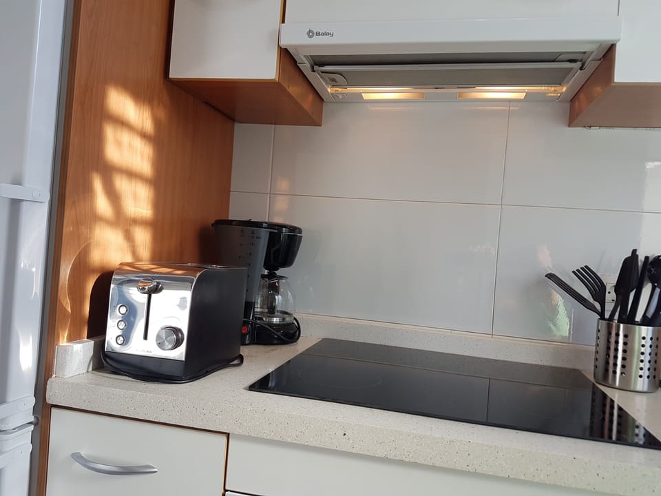 Kitchen with water cooker, fridge / freezer, microwave