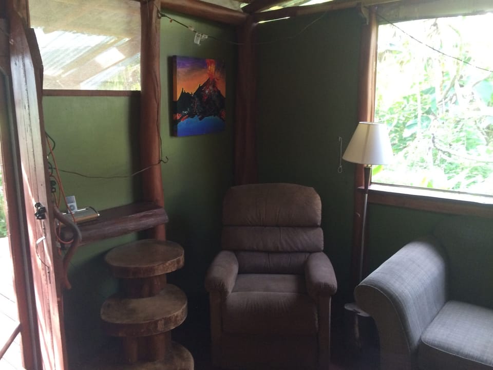 recliner and lava painting in background.