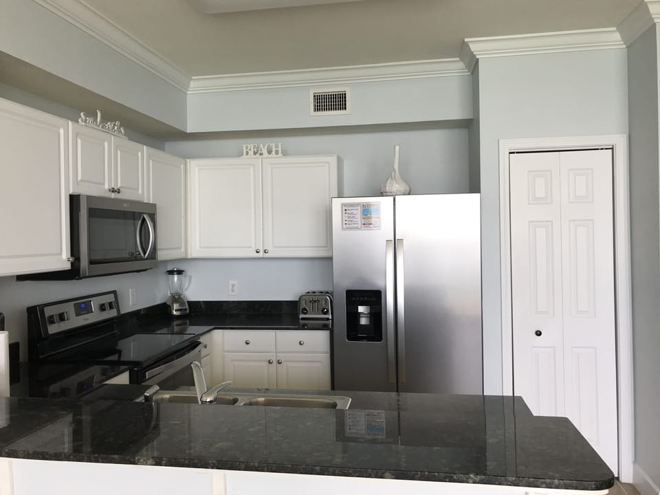 Spacious kitchen pantry and new stainless  side by side refrigerator w ice maker