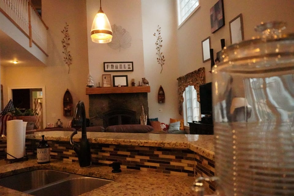 Kitchen bar is open to living room and dining area off the kitchen