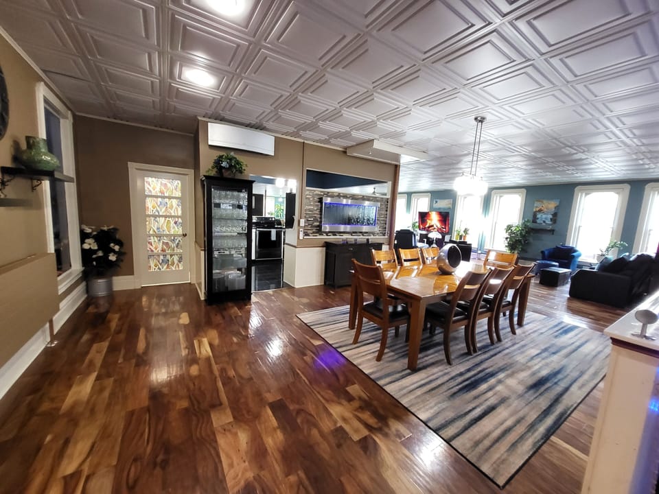 
8 padded leather chairs, dining table, kitchen & bathroom entrances