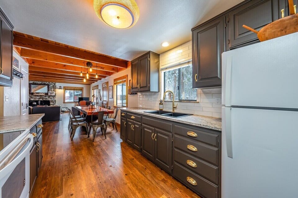 The kitchen is open to the dining area. It is a great space to visit while preparing meals.