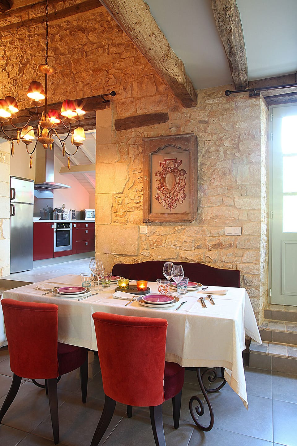 The bright dining area features beautiful 300 years old stone work and beams