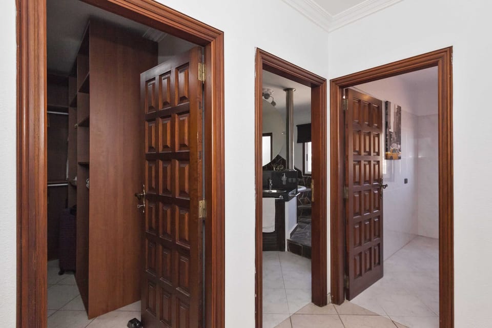Hallway view of walk in wardrobe, main bathroom and WC room.