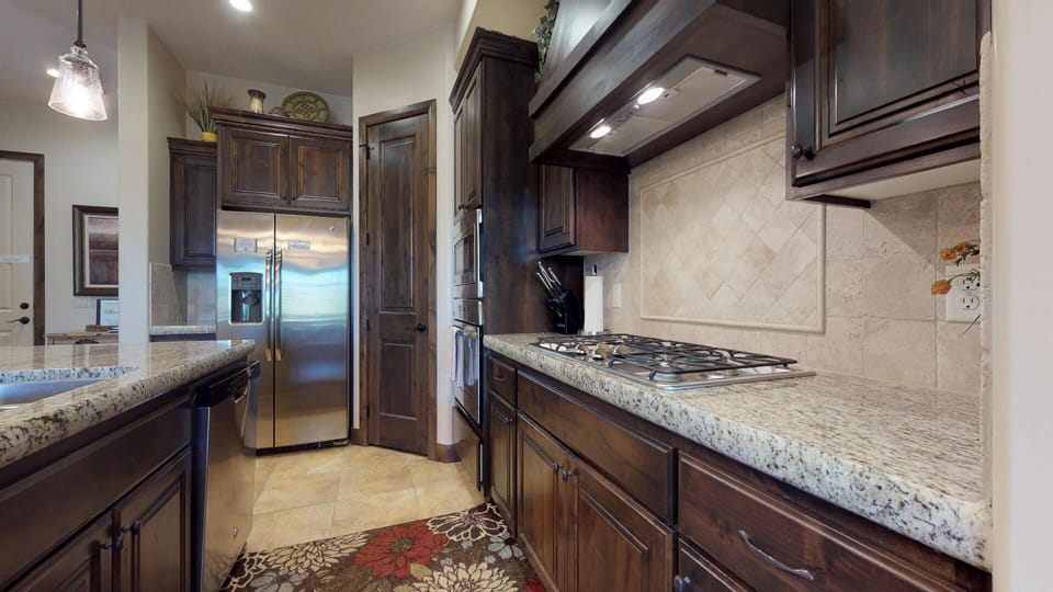 Fully stocked gourmet kitchen featuring granite countertops