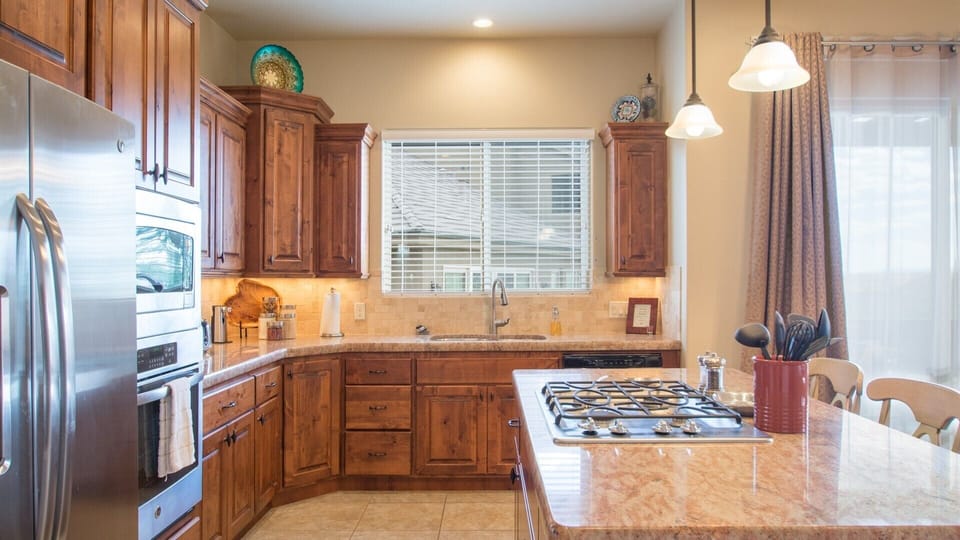 Fully stocked gourmet kitchen featuring granite countertops