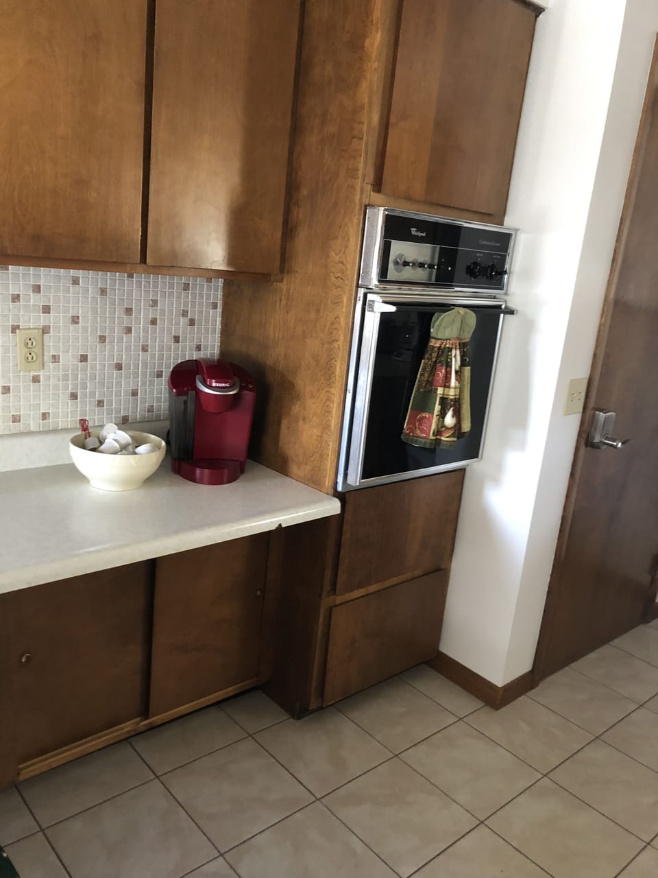 Keurig coffee maker, builit in oven, door to lower level.