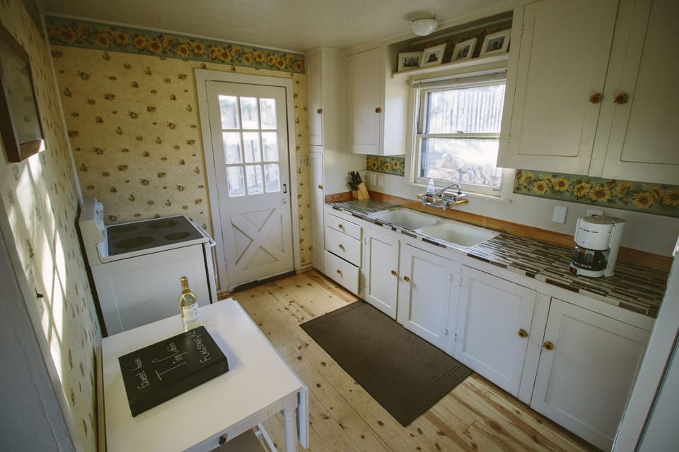 Kitchen.Dinette for two.  Flip up wings on table. Ceramic range. 