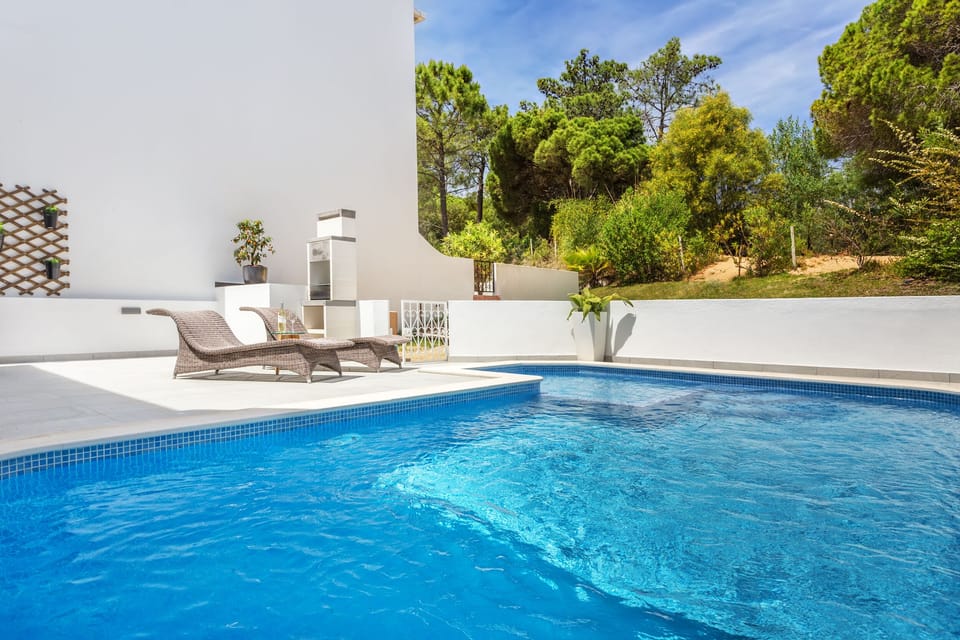 Outside area featuring a heated pool with a kids section, bbq, and lounge area