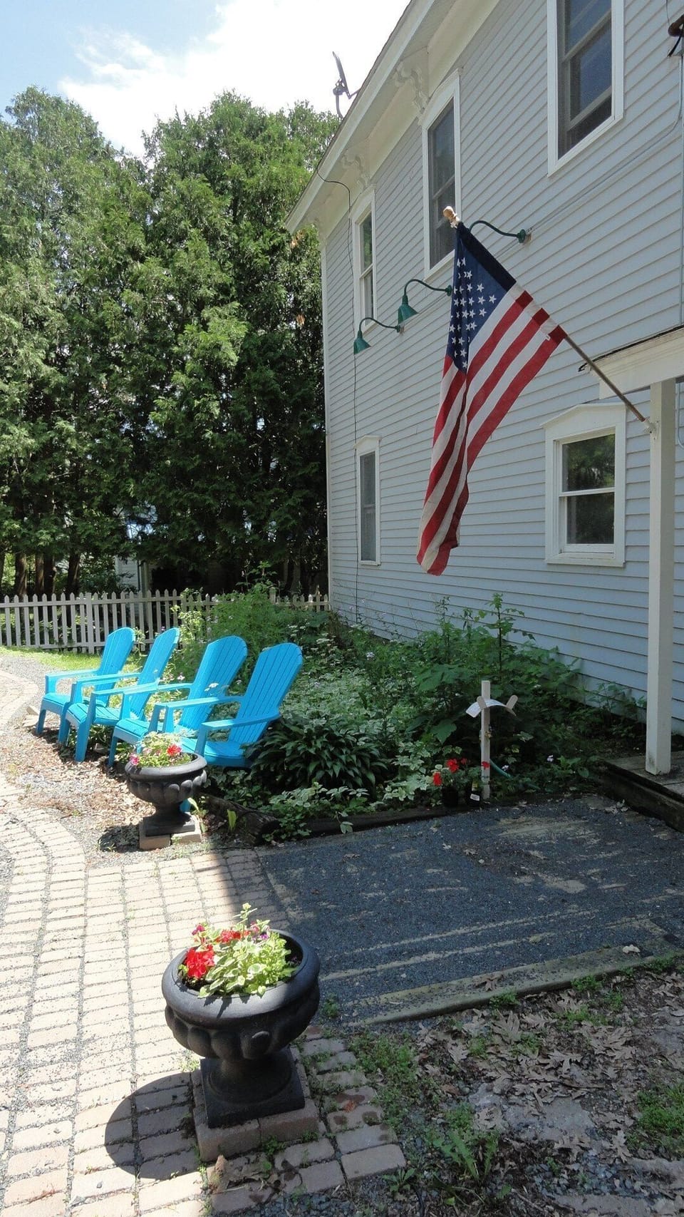 Flowers greet visitors on parking lot side of building during summer months