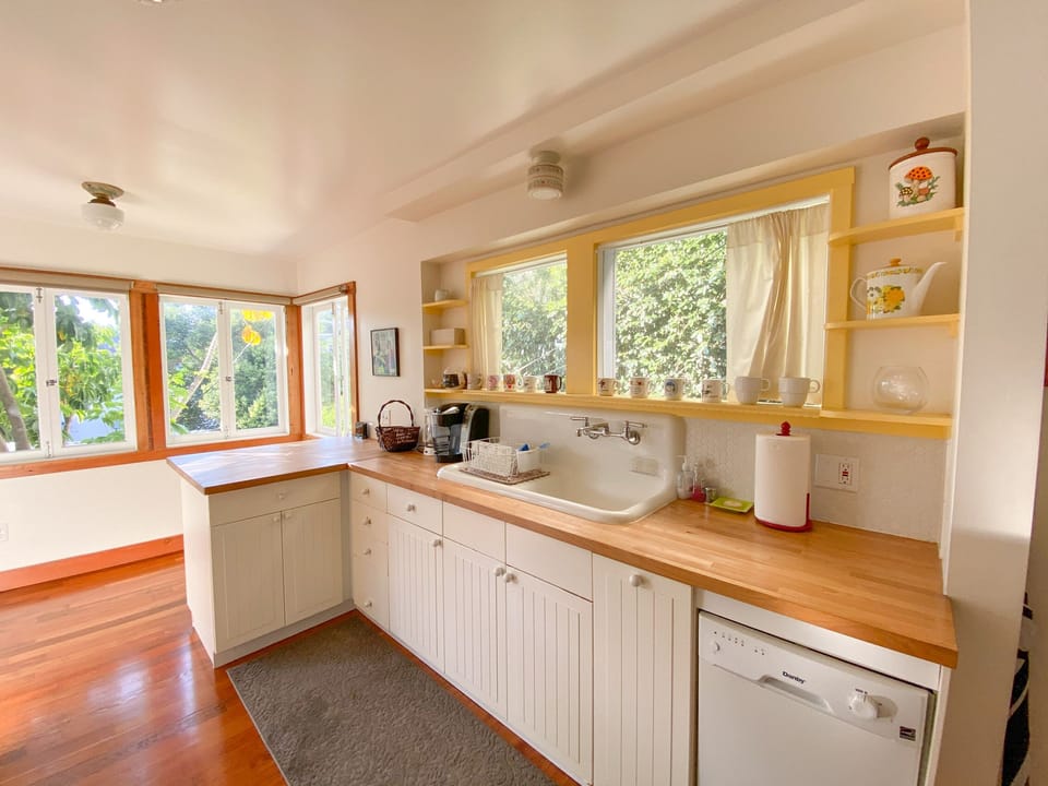 The kitchen has a cute little eat-in counter near the windows, overlooking yard.