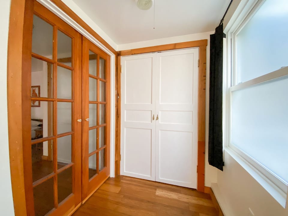 Interior set of French doors between the bedrooms to bring light and air in.