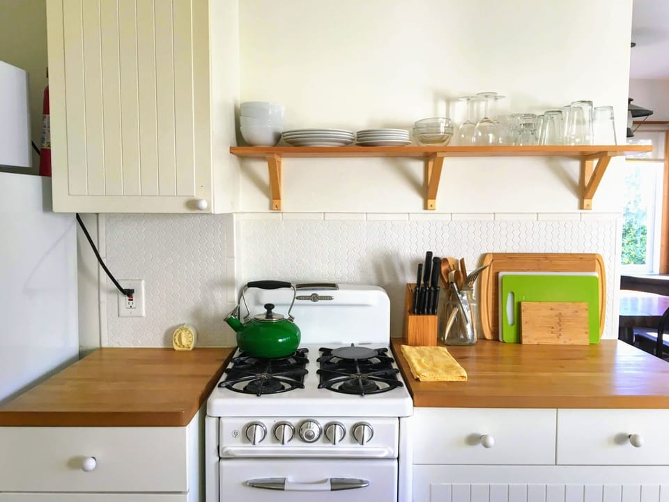 Antique stove and open shelving make this a charming but easy to use kitchen.