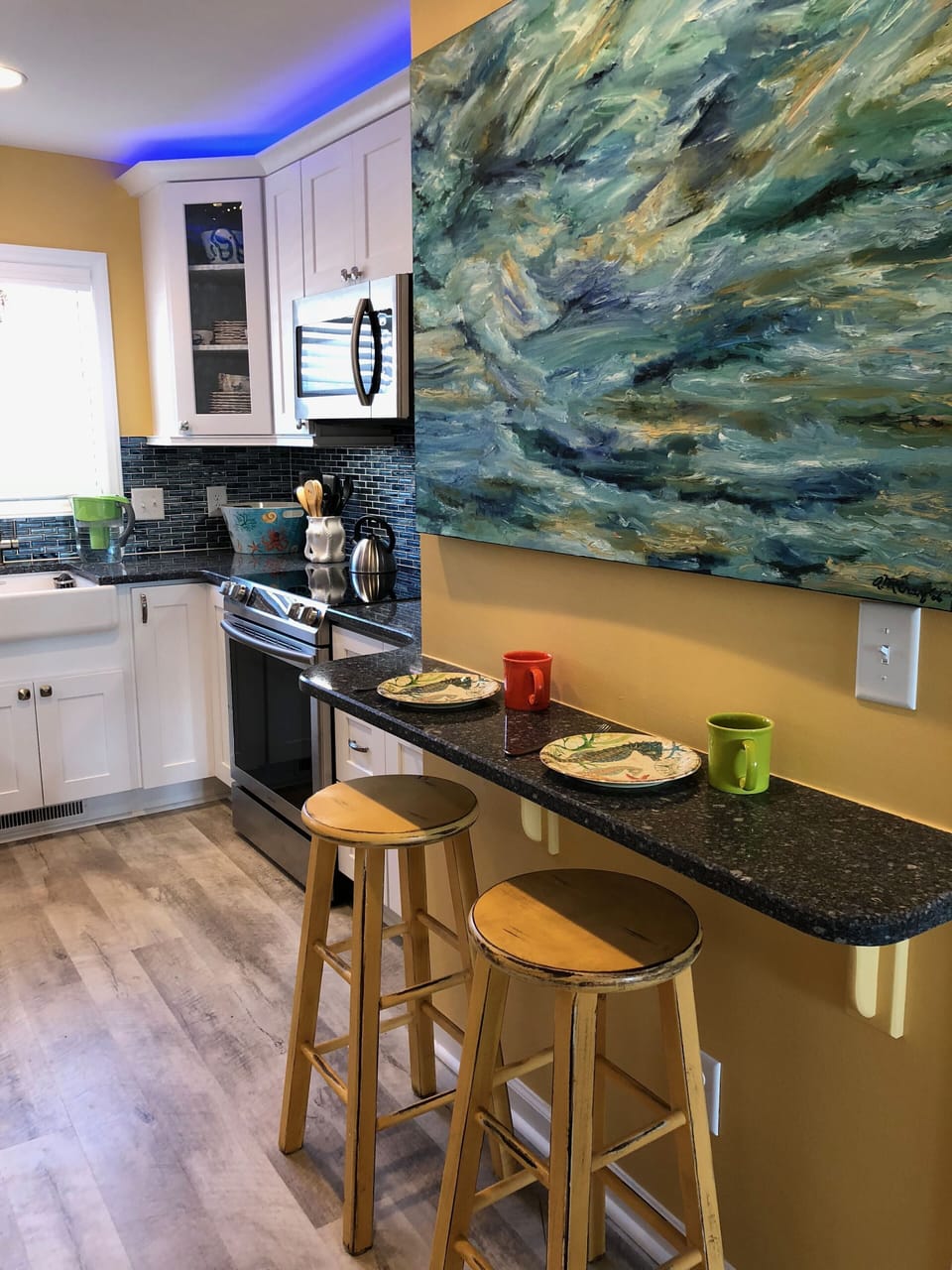 The remodeled kitchen is a cook's dream, & even invites company to stay awhile