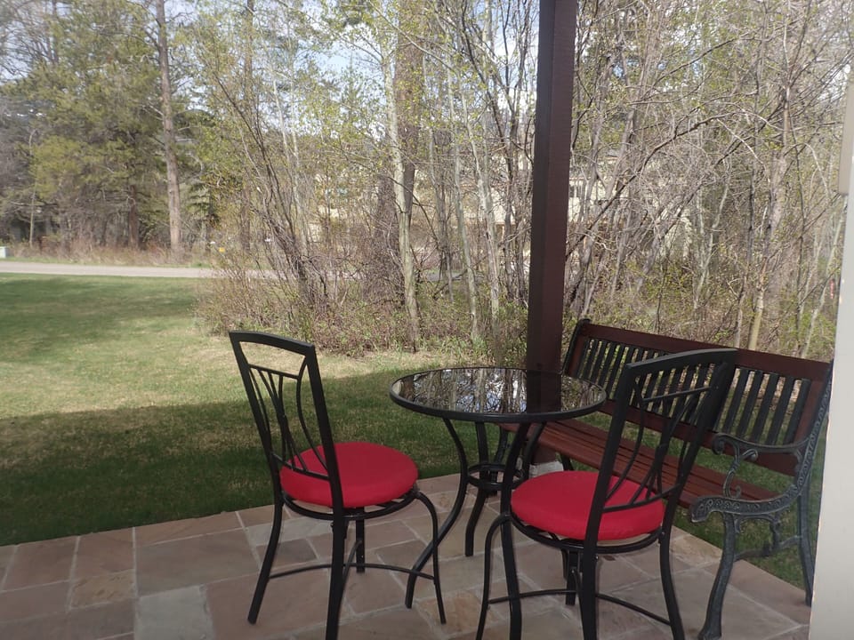 Patio with bistro table and bench with seating for 2