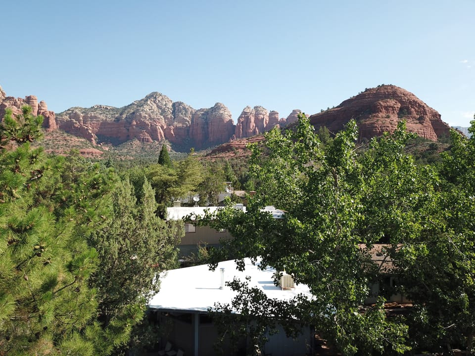 House (white roof) in foreground. Sugarloaf Mtn. and trailhead up the block.