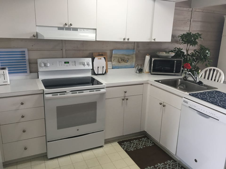 Fully-appointed kitchen with new dishwasher and stove to prep meals and snacks. 