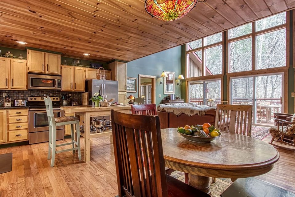 Open concept kitchen, eating area and living room overlooking the river. 