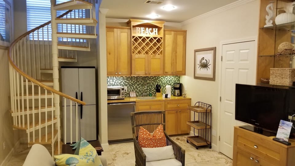 Kitchenette & spiral staircase to upstairs bedroom